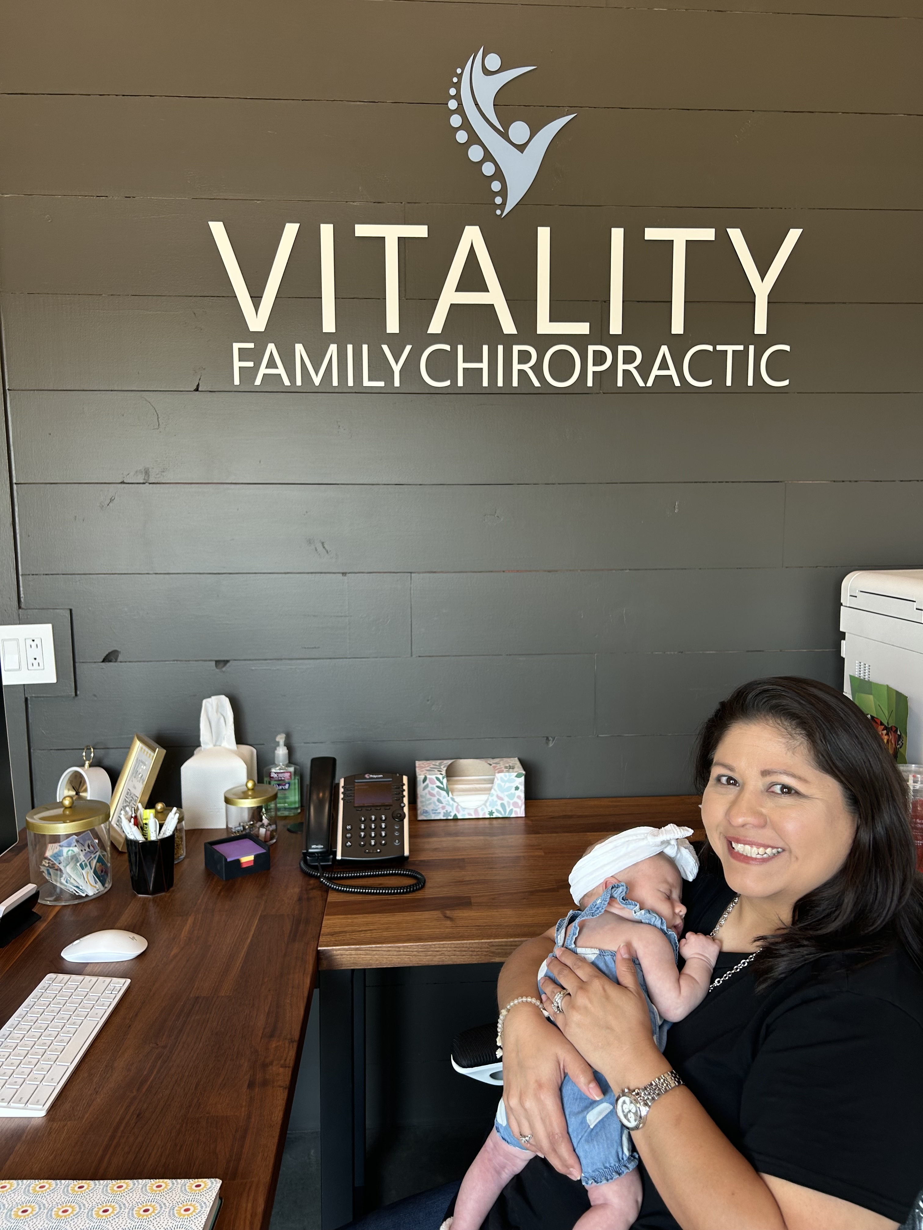 A chiropractor treating a patient laying on a chiropractic table.